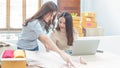 Startup small business owner working with computer at workplace. Freelance two woman seller check product order. Packing goods for Royalty Free Stock Photo