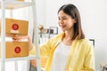 Startup small business, Young Asian woman checking and packing boxes for products to send to customers. Royalty Free Stock Photo