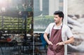 Startup successful small business owner man standing with arms crossed in his coffee shop or restaurant. Royalty Free Stock Photo