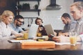 Startup team sitting together at table using laptop in class. Yo Royalty Free Stock Photo