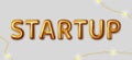 Startup. Vector inscription gold letters on a gray background