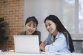 Startup Young asian female students reading books with friends to prepare for exams. Royalty Free Stock Photo