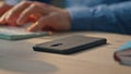 Startuper hands typing keyboard at office desk closeup. Man answering phone call Royalty Free Stock Photo