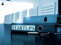 Startups on Ring Binder. Toned Image. 3D. Royalty Free Stock Photo