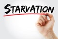 Starvation text with marker Royalty Free Stock Photo