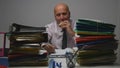 Starved Businessman  Working with Files in Archive Room Eating a Tasty Sandwich Royalty Free Stock Photo