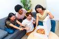 Starved friends ready to eat a delivery pizza at home