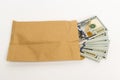 Stash of money in hundred dollar banknotes coming out of envelope