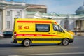 A state ambulance yellow van speeds along a wide city street. Motion blur. Moscow, Russia - April 5, 2019