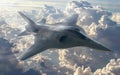 A state-of-the-art fighter jet performs a high-speed maneuver against a backdrop of fluffy white clouds Royalty Free Stock Photo