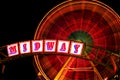 State Fair midway with spinning ferris wheel