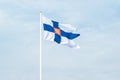 State flag of Finland with national coat of arms against blue sky Royalty Free Stock Photo