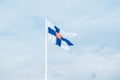 State flag of Finland with national coat of arms against blue sky Royalty Free Stock Photo