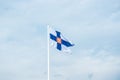 State flag of Finland with national coat of arms against blue sky Royalty Free Stock Photo