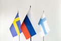 State flag of Russia in focus and Sweden Finland on white background. Conflict, partnership concept Royalty Free Stock Photo