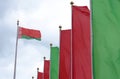 The state flags of the Republic of Belarus are fluttering in the wind, next to red and green flags