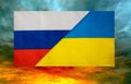 State flags of Russia and Ukraine against the background of the burning sky close-up. Flags.