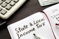 State and local income tax written in note Royalty Free Stock Photo