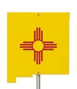 State of New Mexico road sign in the shape of the state map with the flag