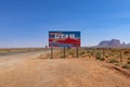 A State of Utah wecome sign aling the US highway 163 leading to the Monument Valley with sandstone buttes on the background Royalty Free Stock Photo