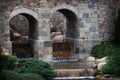 Stately brick arches with waterfalls.