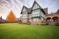 stately tudor house with a wellkept lawn