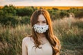 Statement Masks, Blinged out diy flower face mask design. Girl in face mask decorated with flowers on nature background