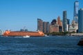Staten Island Ferry crosses in front of New York City skyline Royalty Free Stock Photo