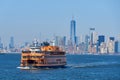 A Staten Island Ferry, in New York Harbor, steams toward the Staten Island Terminal . In the background is the skyline of the NYC Royalty Free Stock Photo