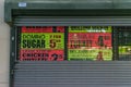 Staten Island, NY / USA - 06/22/2018: Advertisements behind the closed gates of a supermarket