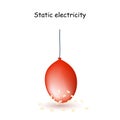 Static Electricity. Red Balloon with pieces of paper