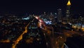 Static shot of the lit up nighttime Atlanta Skyline with traffic below. Freway headlights. Downtown view. Camera