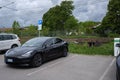 A static shot of a solid black Tesla Model 3 dual motor charging at the Sandefjord municipality AC