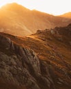 Static tracking view hiker backpacker on black rock trail in Lagodekhi enjoy dramatic sunset over mountain against sun Royalty Free Stock Photo