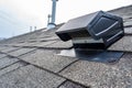 Static vent installed on a shingle roof for passive attic ventilation Royalty Free Stock Photo