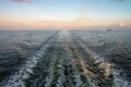 Static wake behind Baltic ferry in sunset light