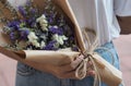 Statice, Sea lavender, marsh rosemary, white and purple color a bouquet of flowers in a woman hand