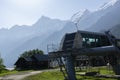 Station with chair lifts that runs near Les Houches. Silhouette of Alpine mountains