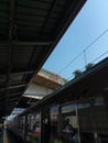 Station commuter line, blue sky and flowers on the bridge
