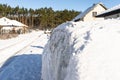 A station wagon car standing in front of a panel fence covered with ice and snow. Royalty Free Stock Photo