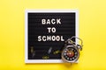 Stationary concept, Flat Lay top view Photo of school items, pencils, paper clips,stapler on yellow background with copy space