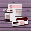 Stationary templates of heart design of business stationery over purple wooden background Royalty Free Stock Photo