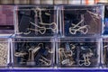 Stationery clothespins in a plastic box close-up, selective focus. Background with copy space