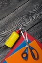 Stationery. Colored paper, scissors and glue. On brushed pine boards Royalty Free Stock Photo