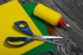 Stationery. Colored paper, scissors and glue. On brushed pine boards Royalty Free Stock Photo