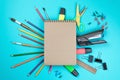 Stationery colorful writing tools accessories pens pencils, Kraft paper isolated on blue background. Back to school. Office suppli Royalty Free Stock Photo