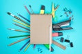 Stationery colorful writing tools accessories pens pencils, Kraft paper isolated on blue background. Back to school. Office suppli Royalty Free Stock Photo