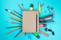 Stationery colorful writing tools accessories pens pencils, Kraft paper isolated on blue background. Back to school. Office suppli Royalty Free Stock Photo