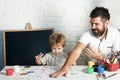 Stationery. Hand drawing. Creative therapy. Father and son draw together. Childhood. A happy family. Stationery shop. Royalty Free Stock Photo