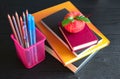 Stationery items on a black table.